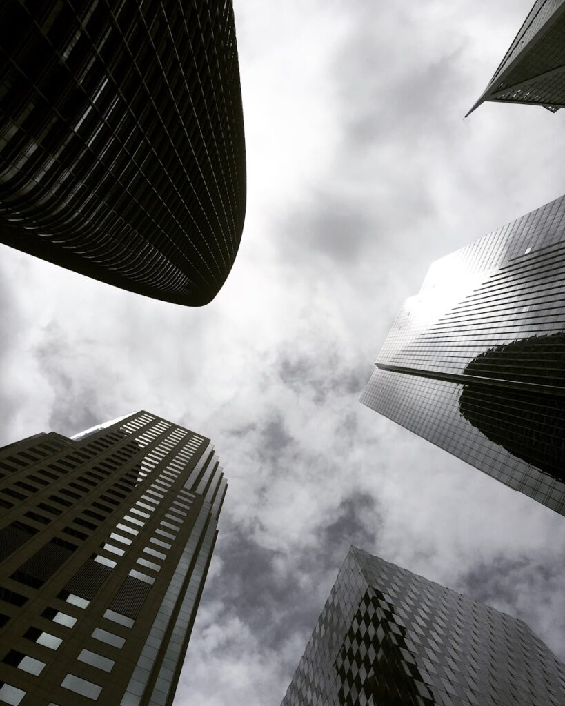high angle photography of glass walled building under white and gray skies